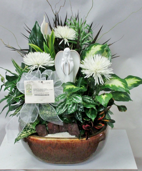 Dish garden of green plants and flowers with an angel keepsake for the garden or home.