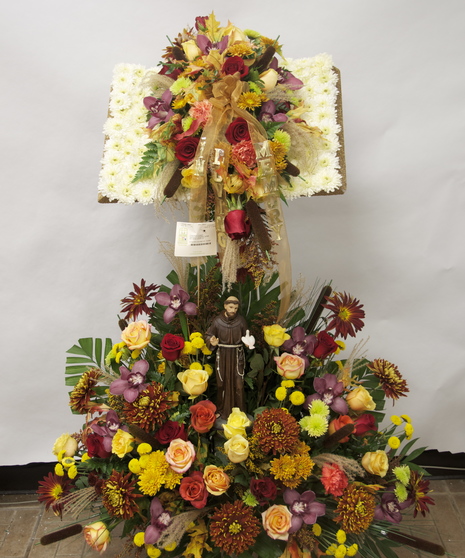 bible stand created with autumnal toned flowers and accented with St. Anthony statue