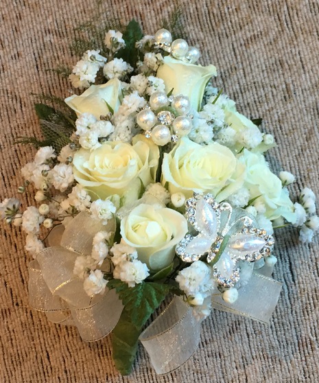 Wristlet with white spray roses and baby's breath adorned with crystals