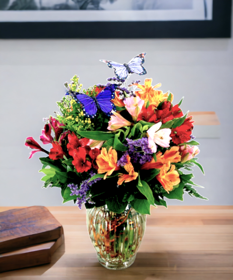 Beautiful alstroemeria accented with Australian wax flower and playful butterflies.