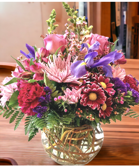 Small vase of purple and lilac flowers.