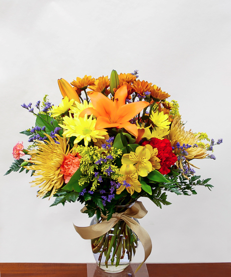 colorful fall toned arrangement in overflowing English garden design