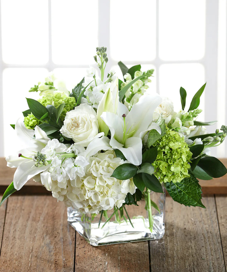 white garden style bouquet in modern glass cube